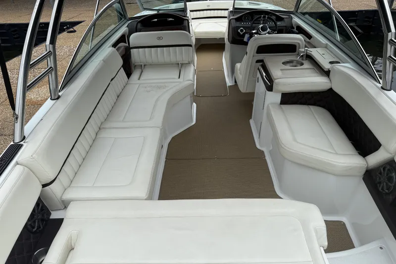 Slide: The Image of 2013 Cobalt A28 boat interior with white leather seating and modern dashboard. - 35
