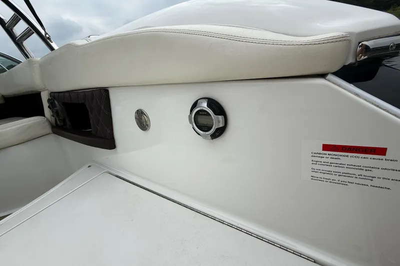 Slide: The Image of 2013 Cobalt A28 boat interior with warning label and control panel. - 37