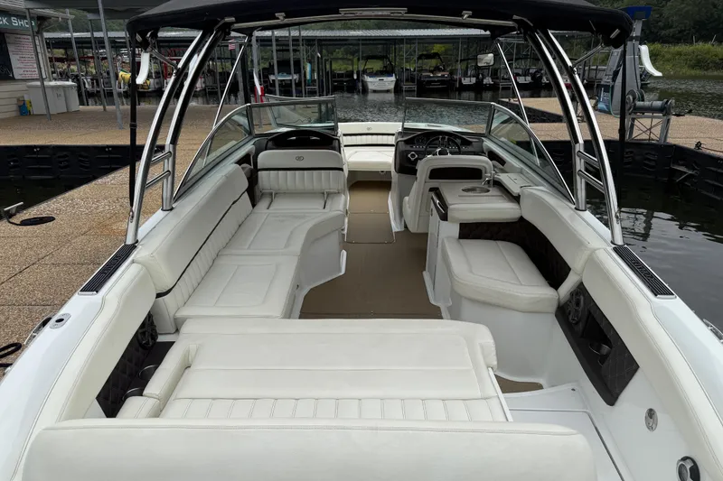 Slide: The Image of 2013 Cobalt A28 boat with spacious white interior and sleek design at a dock. - 39