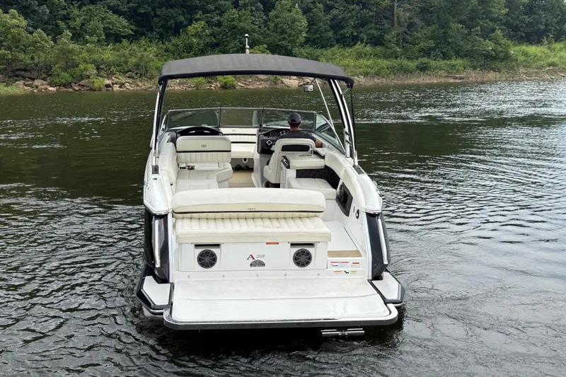Slide: The Image of 2013 Cobalt A28 boat on a calm lake with lush green shoreline. - 4