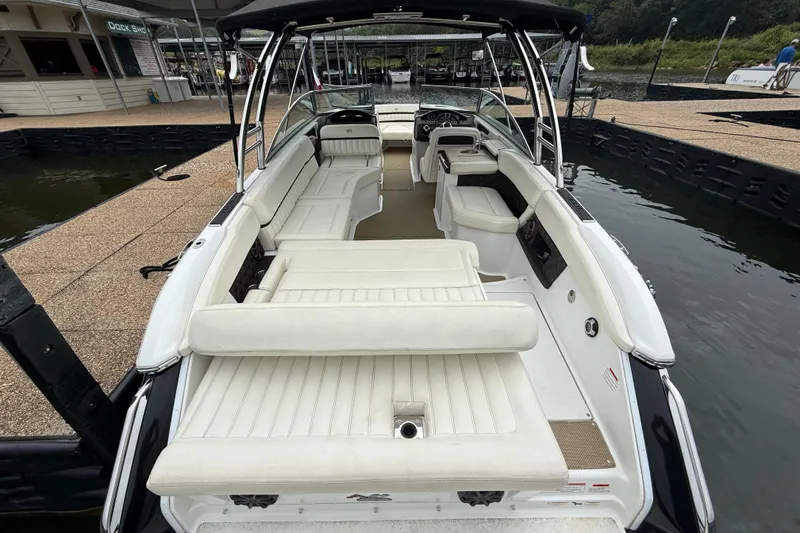 Slide: The Image of 2013 Cobalt A28 boat with spacious white seating at a dock. - 40