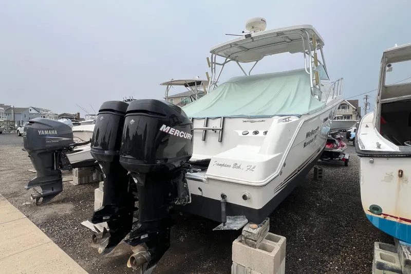 Slide: The Image of 2001 Wellcraft 290 Coastal boat with dual Mercury outboard engines on display. - 5