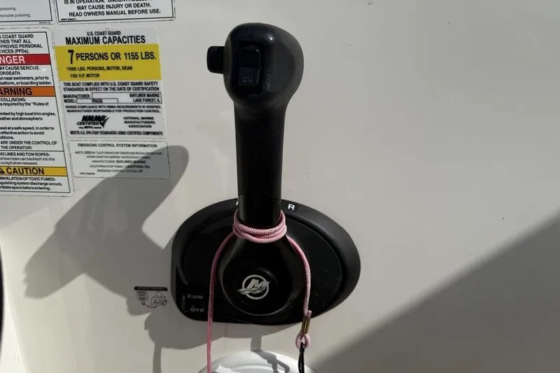 Slide: The Image of Throttle control of 2020 Bayliner VR4 Bowrider with capacity and safety labels. - 14