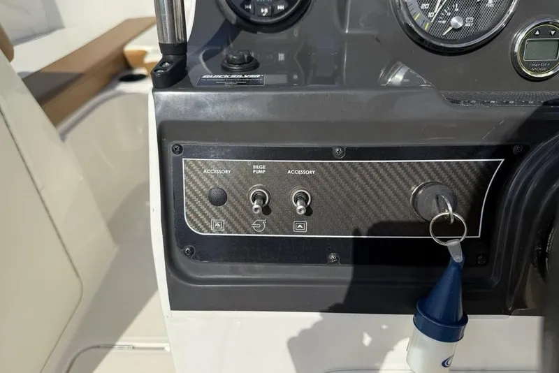Slide: The Image of Control panel of a 2020 Bayliner VR4 Bowrider boat with accessory switches and ignition key. - 15