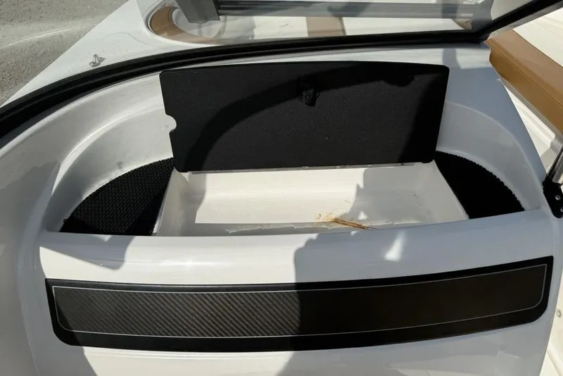 Slide: The Image of 2020 Bayliner VR4 Bowrider storage compartment with open hatch, showcasing interior space. - 17
