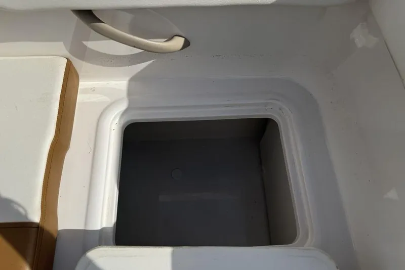 Slide: The Image of 2020 Bayliner VR4 Bowrider storage compartment with white and brown seating. - 21