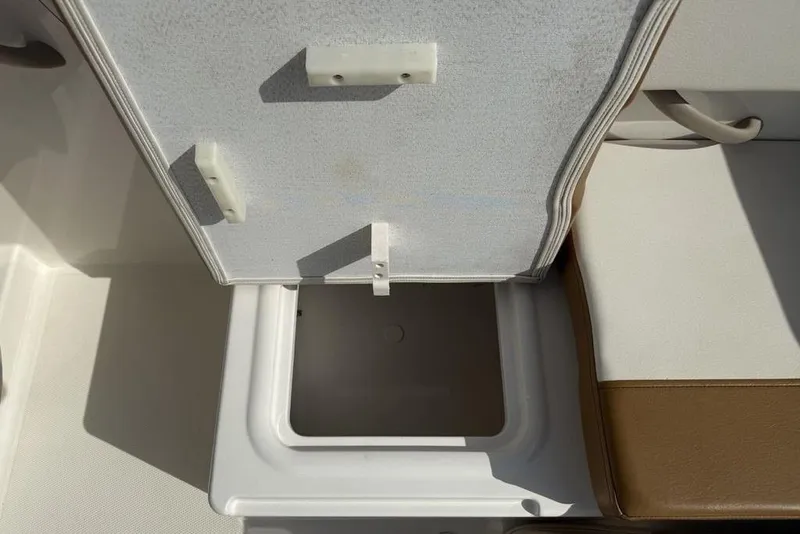 Slide: The Image of 2020 Bayliner VR4 Bowrider storage compartment with open lid, showcasing interior space. - 24
