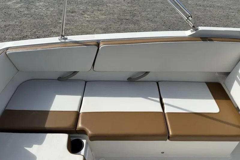 Slide: The Image of 2020 Bayliner VR4 Bowrider interior seating with brown and white cushions. - 26