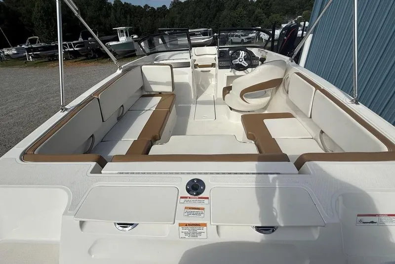 Slide: The Image of 2020 Bayliner VR4 Bowrider interior with white and tan seating, steering wheel visible. - 28