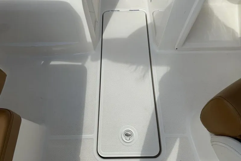Slide: The Image of 2020 Bayliner VR4 Bowrider interior storage compartment with beige seating. - 29