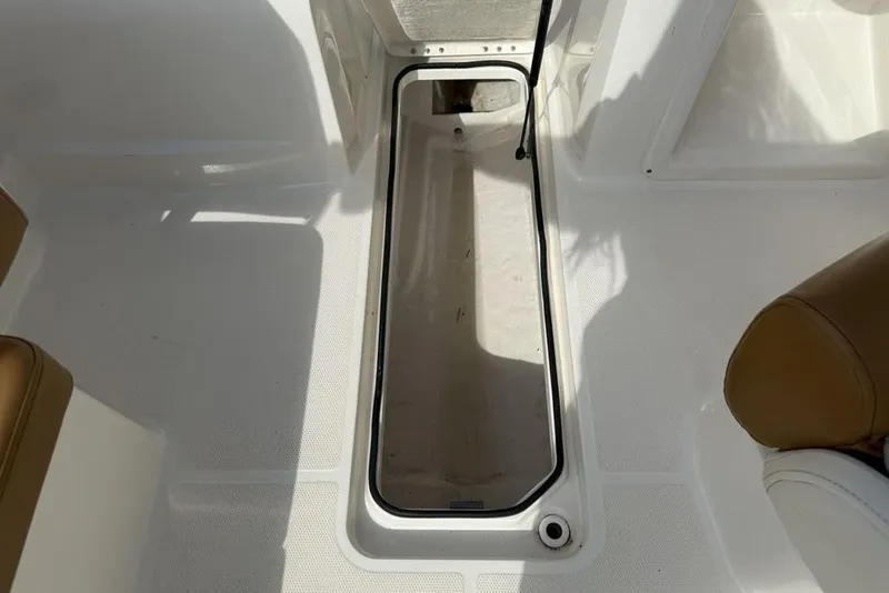 Slide: The Image of 2020 Bayliner VR4 Bowrider interior storage compartment with white and tan seating. - 31