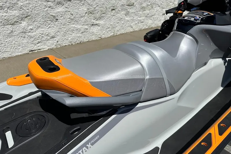 Slide: The Image of 2023 Sea-Doo Fish Pro Trophy jet ski seat, featuring sleek gray and orange design. - 16