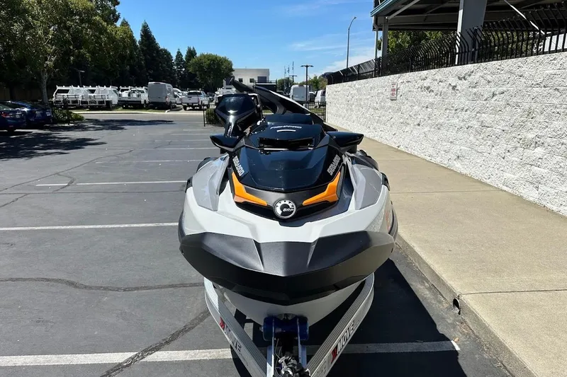 Slide: The Image of 2023 Sea-Doo Fish Pro Trophy jet ski parked in a lot, front view. - 2