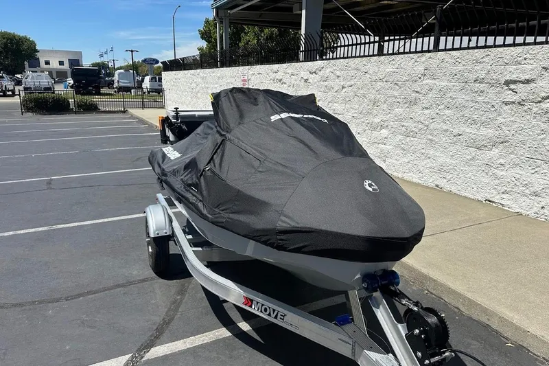 Slide: The Image of 2023 Sea-Doo Fish Pro Trophy covered on trailer in parking lot. - 21