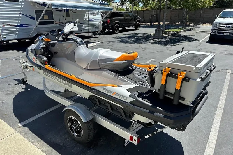 Slide: The Image of 2023 Sea-Doo Fish Pro Trophy on trailer, parked in sunny lot. - 4