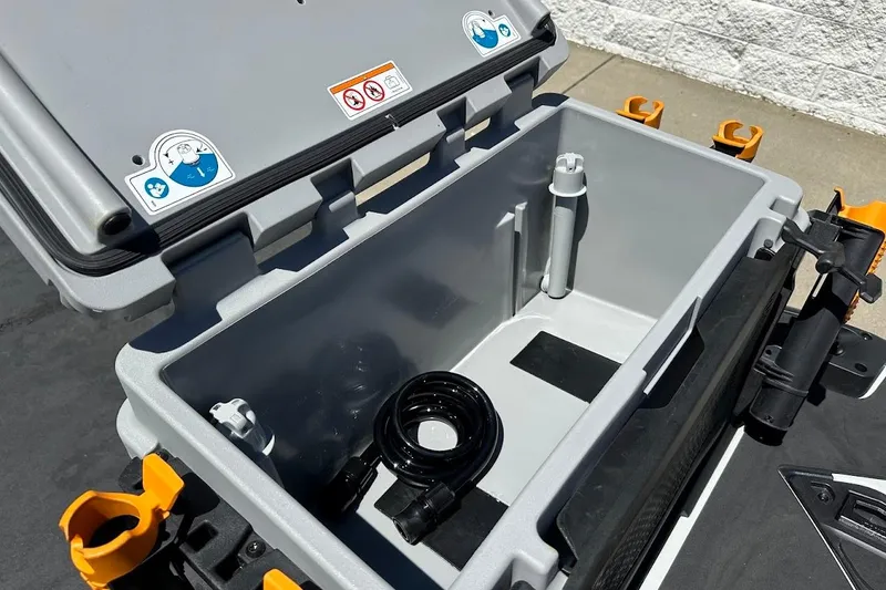 Slide: The Image of 2023 Sea-Doo Fish Pro Trophy storage compartment with open lid and accessories. - 7