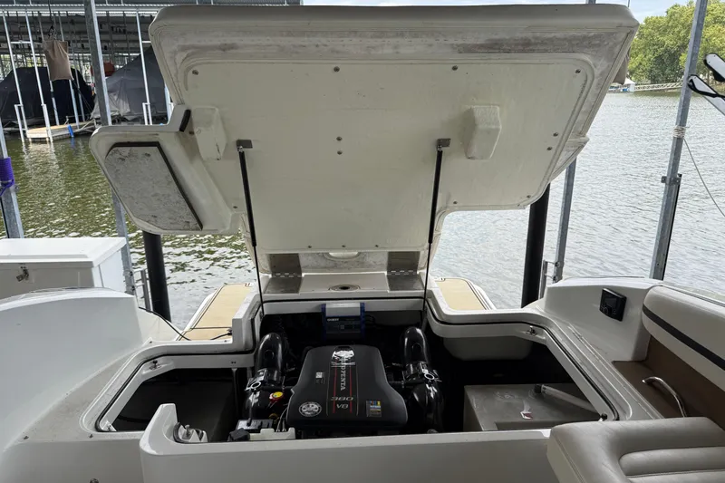 Slide: The Image of 2016 Cobalt R5 WSS Surf boat engine compartment open by the water. - 12