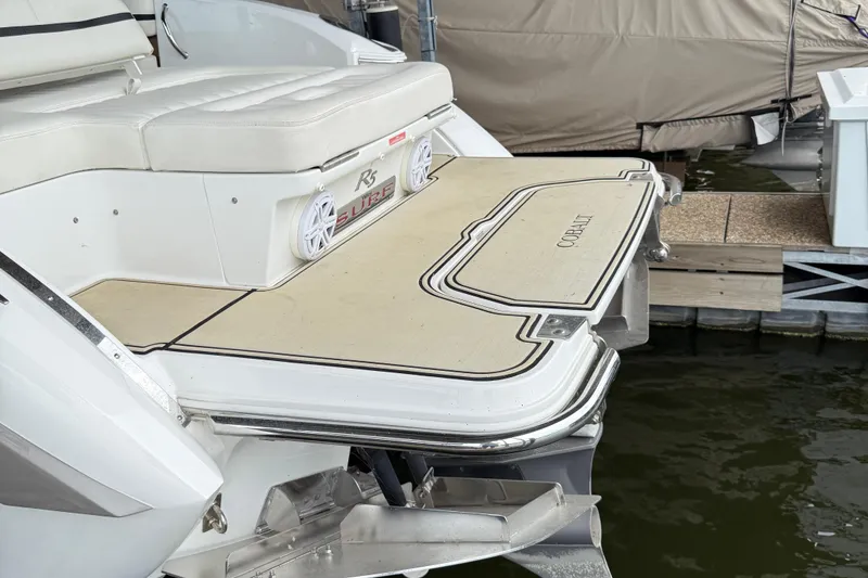 Slide: The Image of 2016 Cobalt R5 WSS Surf boat with swim platform and speakers at dock. - 16