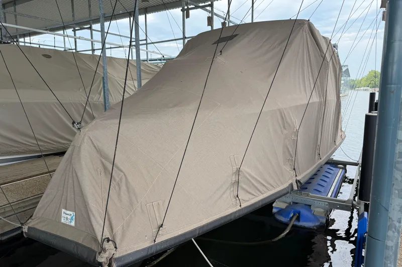 Slide: The Image of 2016 Cobalt R5 WSS Surf boat covered and docked in a marina. - 17