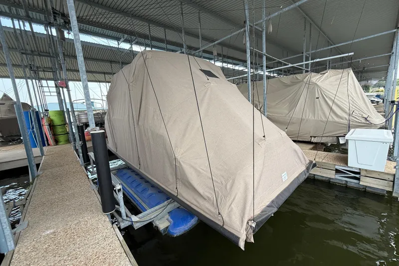 Slide: The Image of Covered 2016 Cobalt R5 WSS Surf boat docked in a marina. - 18