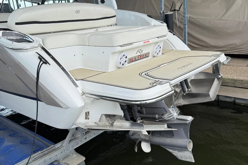 Slide: The Image of 2016 Cobalt R5 WSS Surf boat with swim platform and seating, docked at marina. - 22