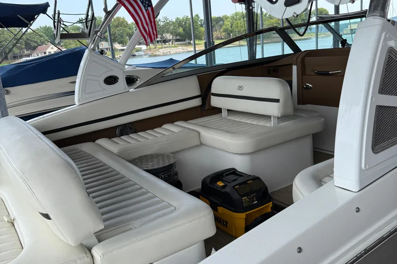 Slide: The Image of 2016 Cobalt R5 WSS Surf boat interior with white seating and American flag. - 25
