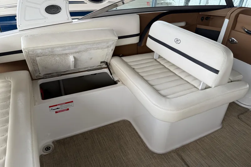 Slide: The Image of 2016 Cobalt R5 WSS Surf boat interior with open storage compartment and white seating. - 26