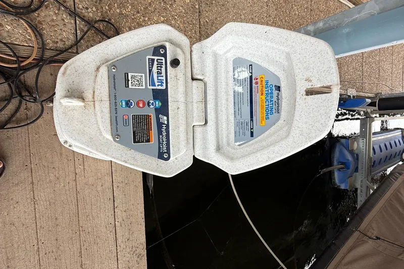 Slide: The Image of HydroHoist boat lift system on dock, featuring UltraLift Series controls. - 28