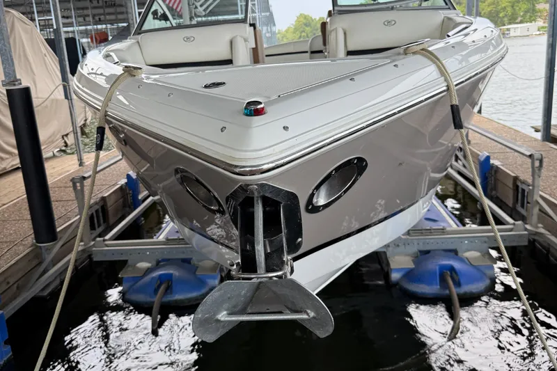 Slide: The Image of 2016 Cobalt R5 WSS Surf boat docked, front view with ropes and water reflection. - 5