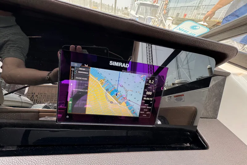 Slide: The Image of Simrad navigation display on 2020 Sea Ray boat dashboard, showing map and engine data. - 10