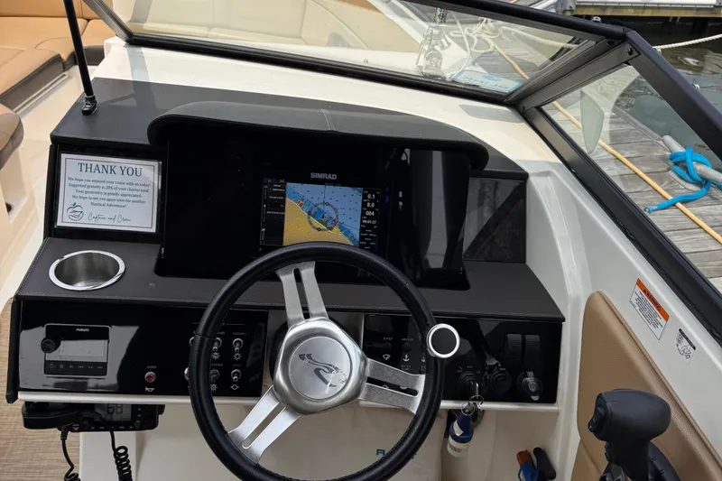 Slide: The Image of 2020 Sea Ray boat dashboard with navigation system and steering wheel at dock. - 11
