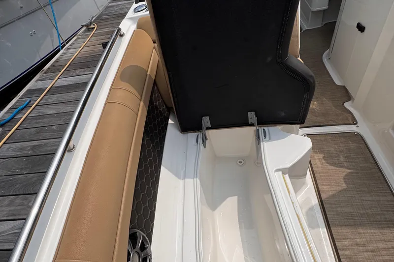 Slide: The Image of 2020 Sea Ray boat interior with open storage compartment and tan seating. - 15