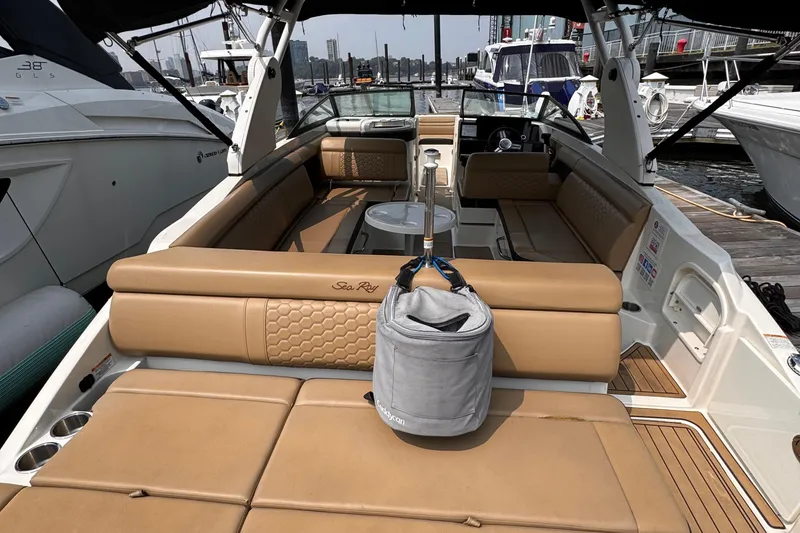 Slide: The Image of Luxury 2020 Sea Ray boat interior with tan seating, docked at marina. - 22