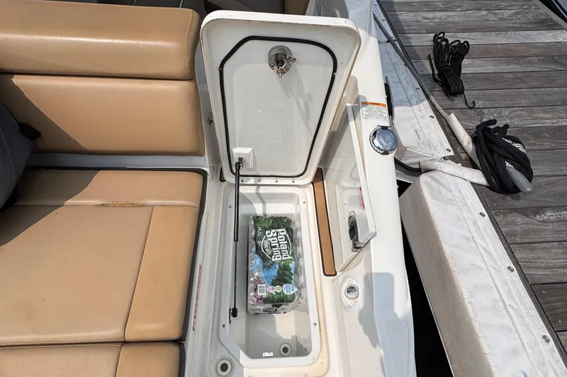 Slide: The Image of Open storage compartment on 2020 Sea Ray boat with bottled water inside. - 23