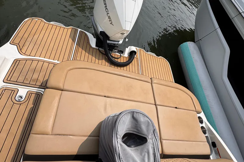 Slide: The Image of 2020 Sea Ray boat with tan seating and Mercury outboard motor on water. - 24