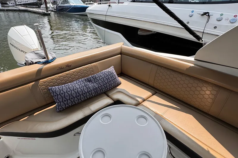 Slide: The Image of Luxurious 2020 Sea Ray boat interior with tan seating and decorative pillow. - 26