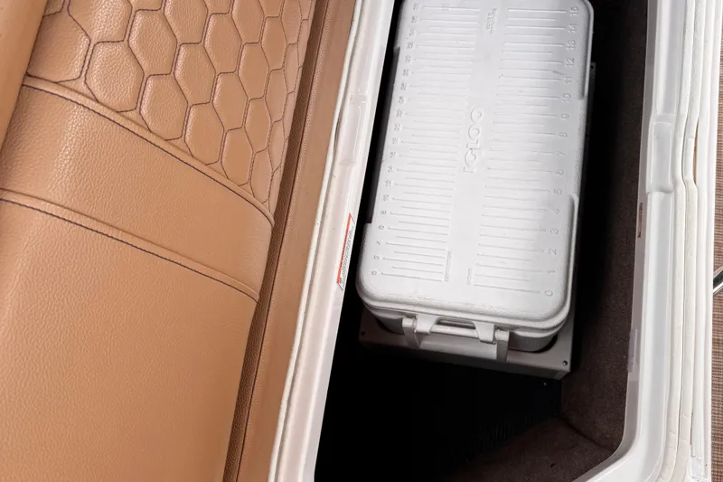 Slide: The Image of Storage compartment in 2020 Sea Ray boat with white Igloo cooler and tan leather upholstery. - 28
