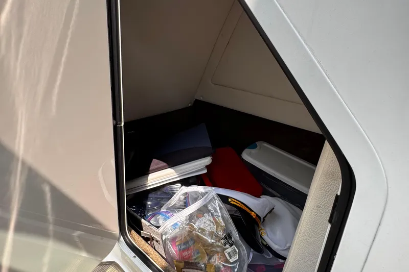 Slide: The Image of Storage compartment on a 2020 Sea Ray boat, containing various items and supplies. - 29