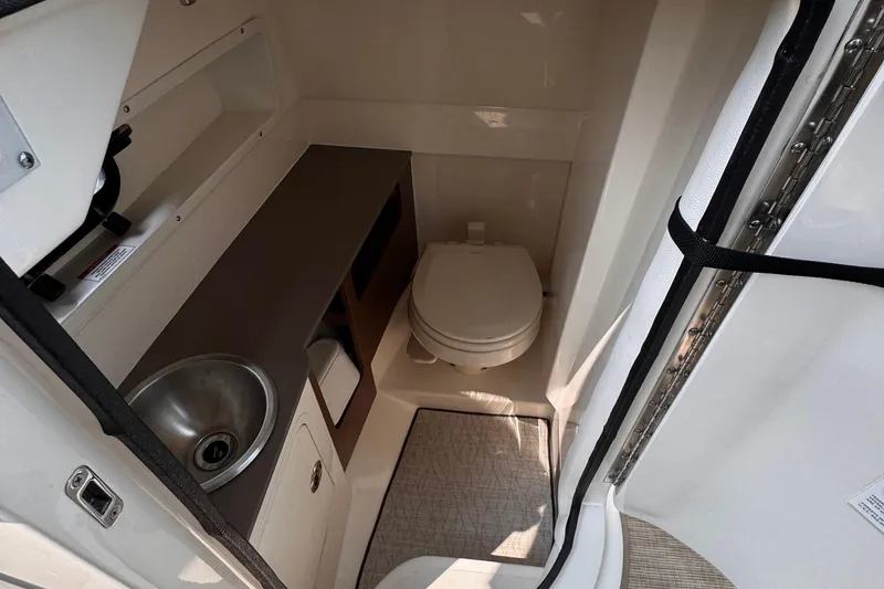 Slide: The Image of 2020 Sea Ray boat bathroom with sink, toilet, and storage area. - 31