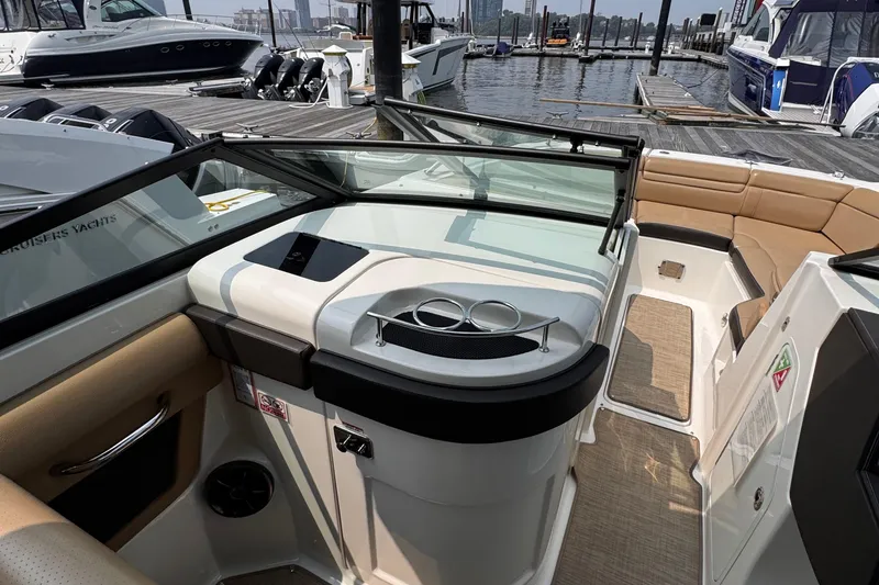 Slide: The Image of 2020 Sea Ray boat interior with seating and dashboard, docked at marina. - 32
