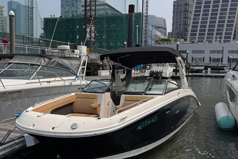 Slide: The Image of 2020 Sea Ray boat docked in urban marina with modern buildings in background. - 4