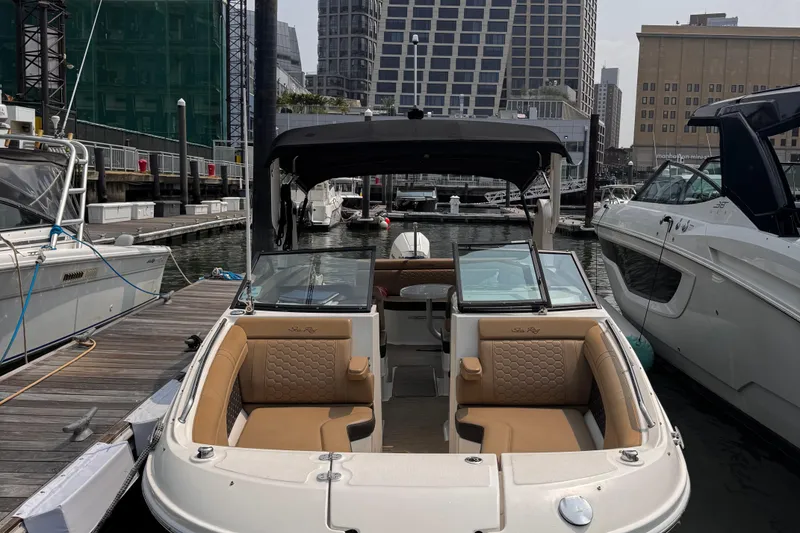 Slide: The Image of 2020 Sea Ray boat docked at marina with urban skyline backdrop. - 5