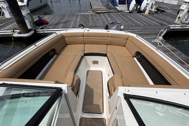Slide: The Image of 2020 Sea Ray boat interior with tan seating at a marina dock. - 9