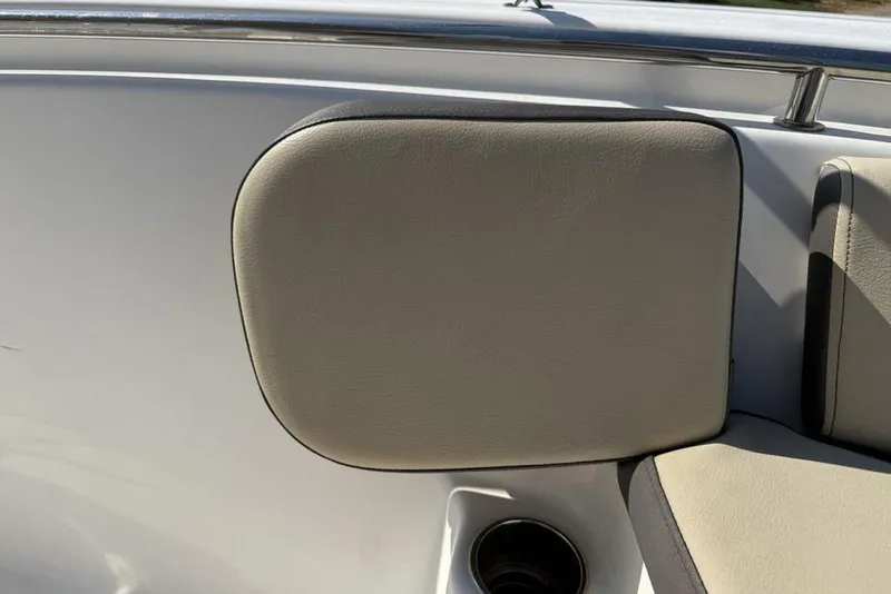 Slide: The Image of 2020 Tidewater 198 CC Adventure boat interior with cushioned seating and cup holder. - 11