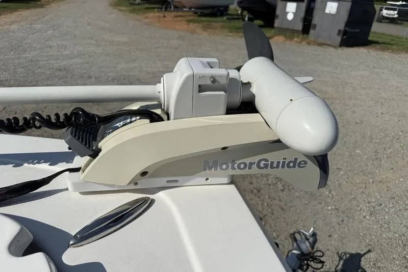 Slide: The Image of MotorGuide trolling motor on 2020 Tidewater 198 CC Adventure boat, parked on gravel. - 13