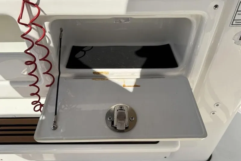 Slide: The Image of Open storage compartment on 2020 Tidewater 198 CC Adventure boat with red coiled cord. - 22
