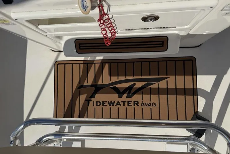 Slide: The Image of 2020 Tidewater 198 CC Adventure boat deck with branded mat and safety features. - 23