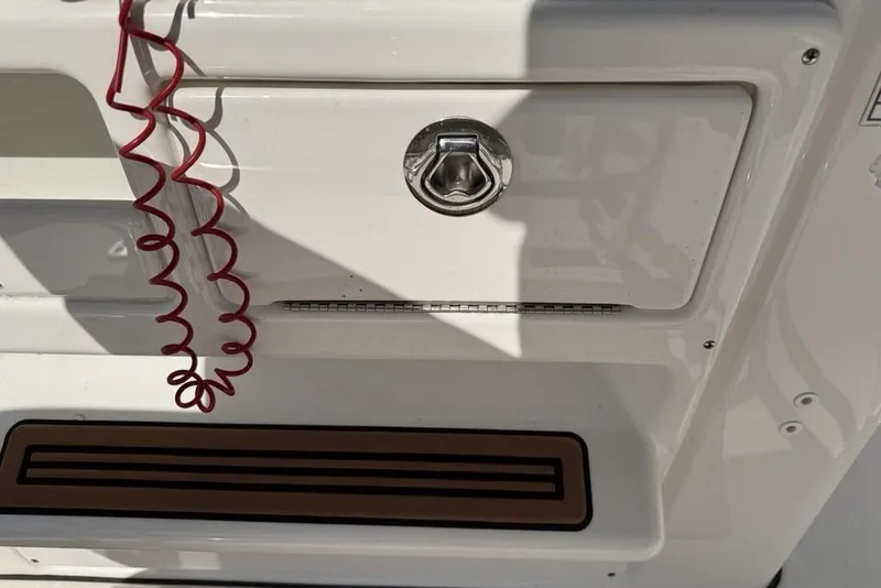 Slide: The Image of 2020 Tidewater 198 CC Adventure boat detail with red safety cord and storage compartment. - 24