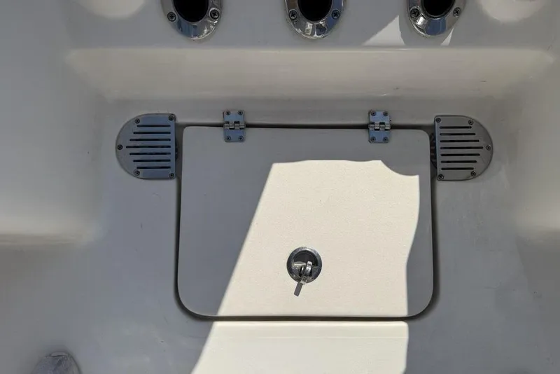 Slide: The Image of 2020 Tidewater 198 CC Adventure boat storage compartment with metal hinges and latch. - 30