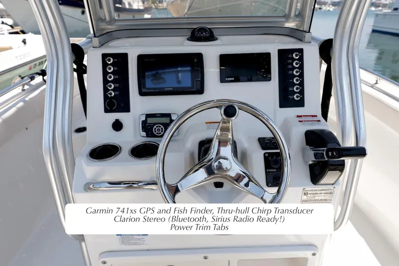 Slide: The Image of 2016 Robalo R222 Center Console dashboard with Garmin GPS, stereo, and controls. - 6